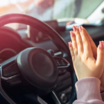 Person praying beside a car before driving, asking God for protection and safe travel.