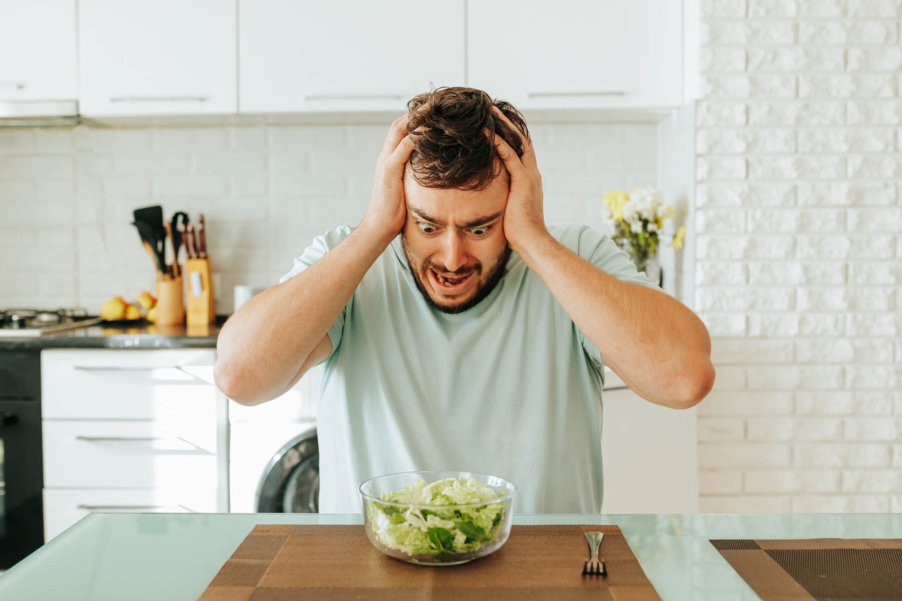 sitting in the kitchen a young man looks with hor 2023 11 27 05 19 51 utc